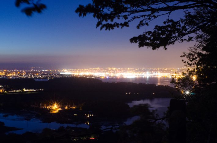 Street lighting creates an artificial glow in the night sky above Plymouth and the surrounding areas.
