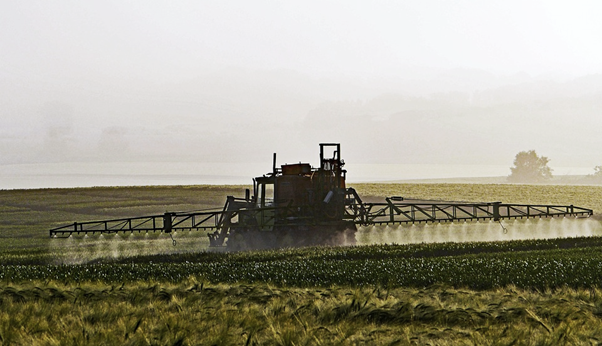 Photo of a tractor irrigating farmland