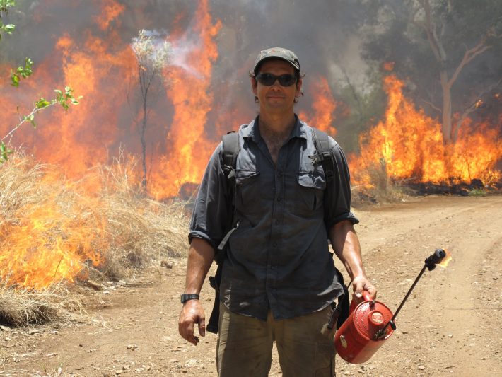 Fire management performed with a drip torch to combat biodiversity threats